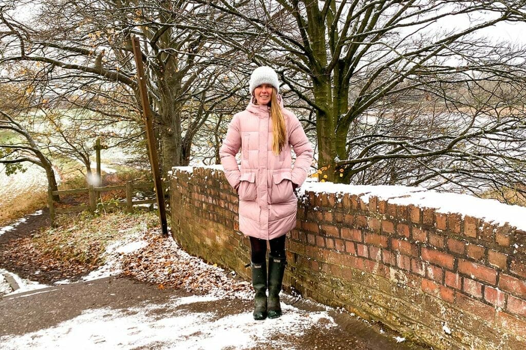 woman-standing-on-bridge-with-snow