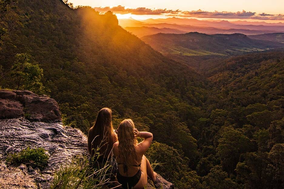 moving-to-london-gold-coast-hinterland-women-sitting-on-clff-looking-at-sunset